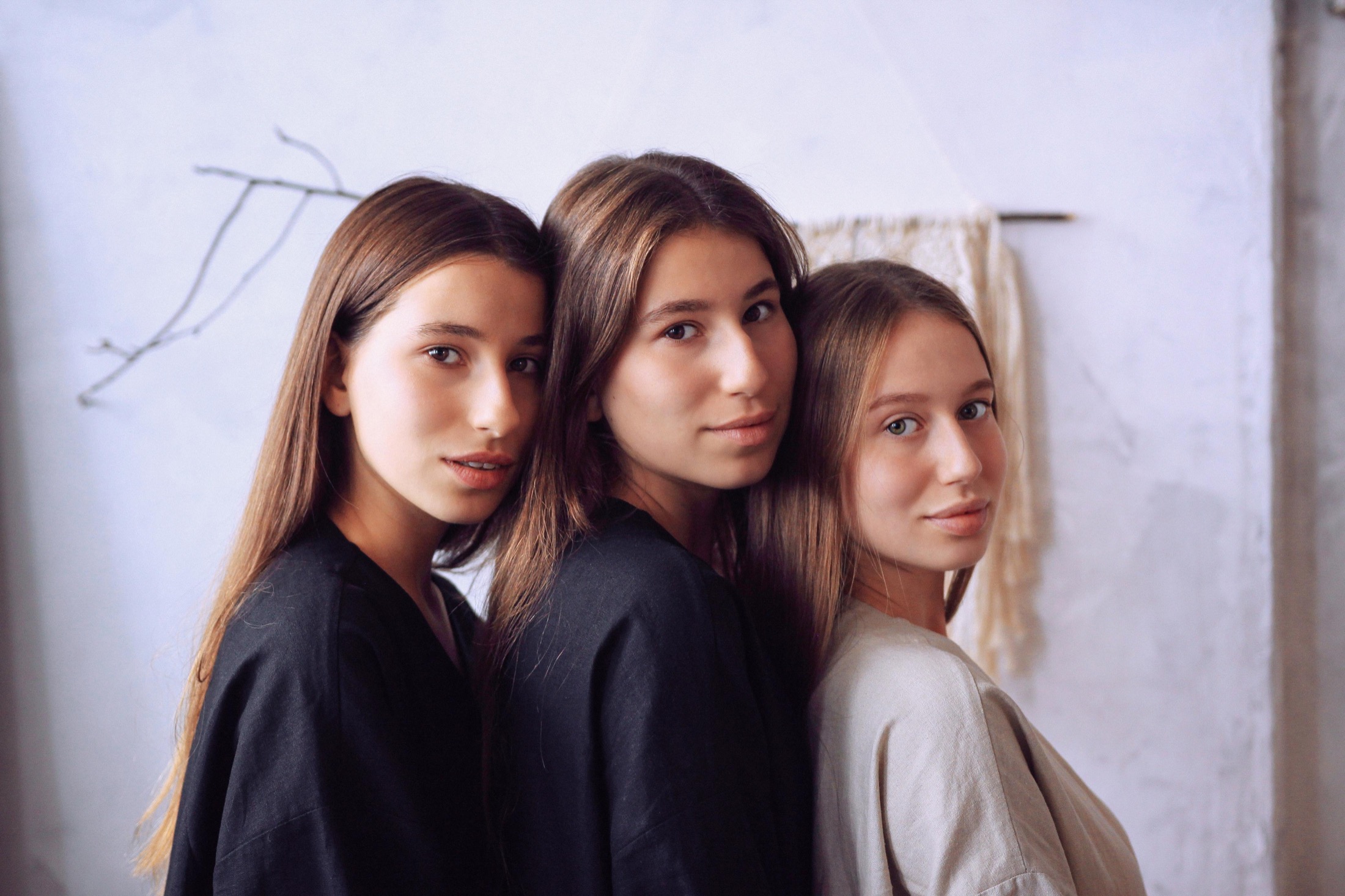 Three models in Veresk Clothes robes facing camera