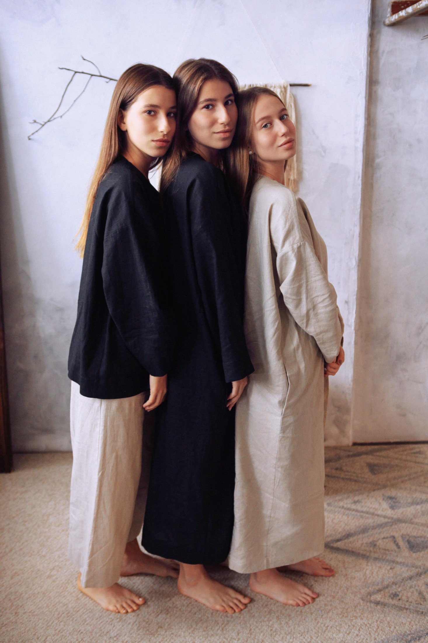 Three models standing in neutral Veresk Clothes robes