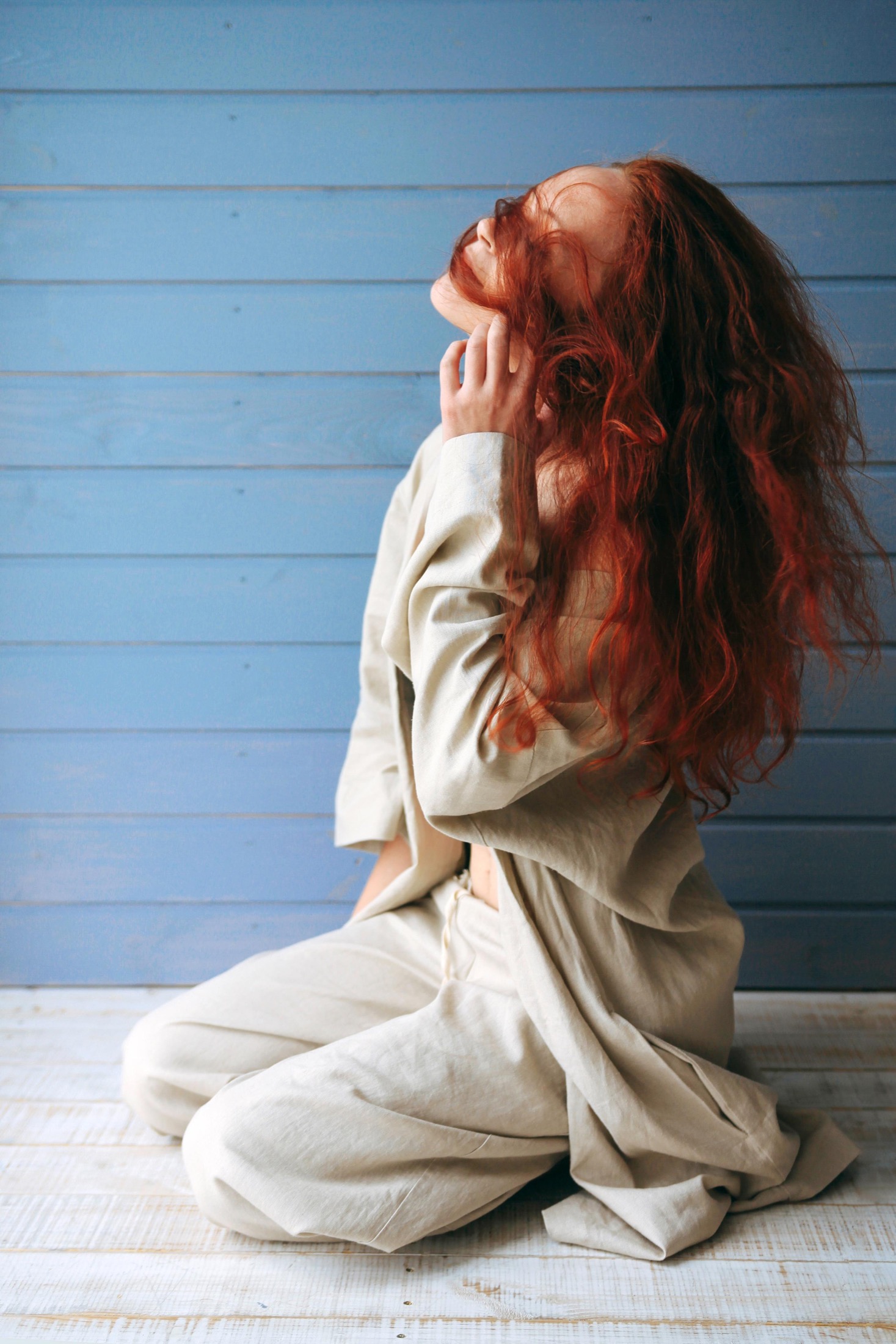 Red-haired model seated in a light Veresk Clothes robe