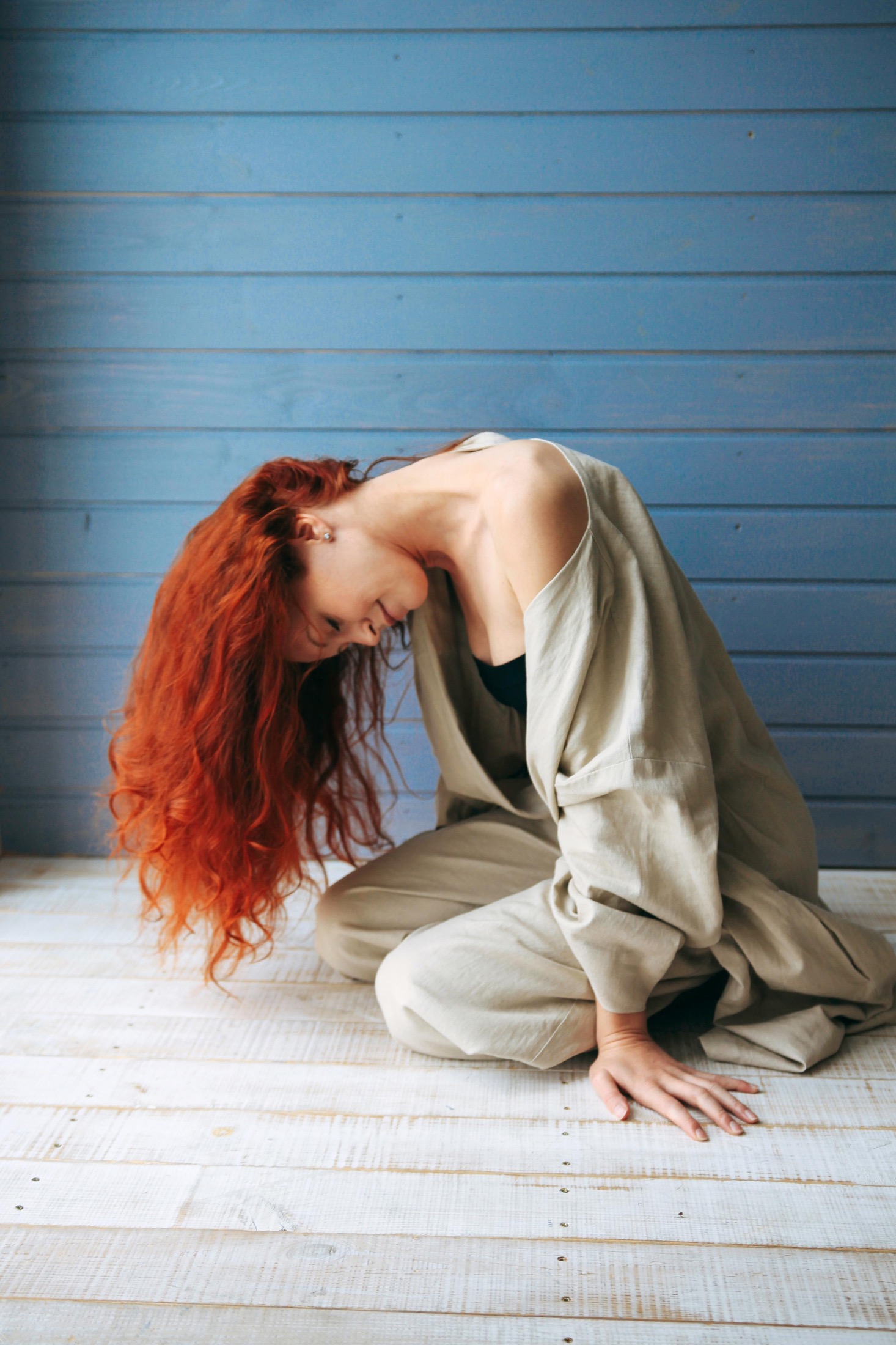 Red-haired model leaning forward in a light Veresk Clothes robe