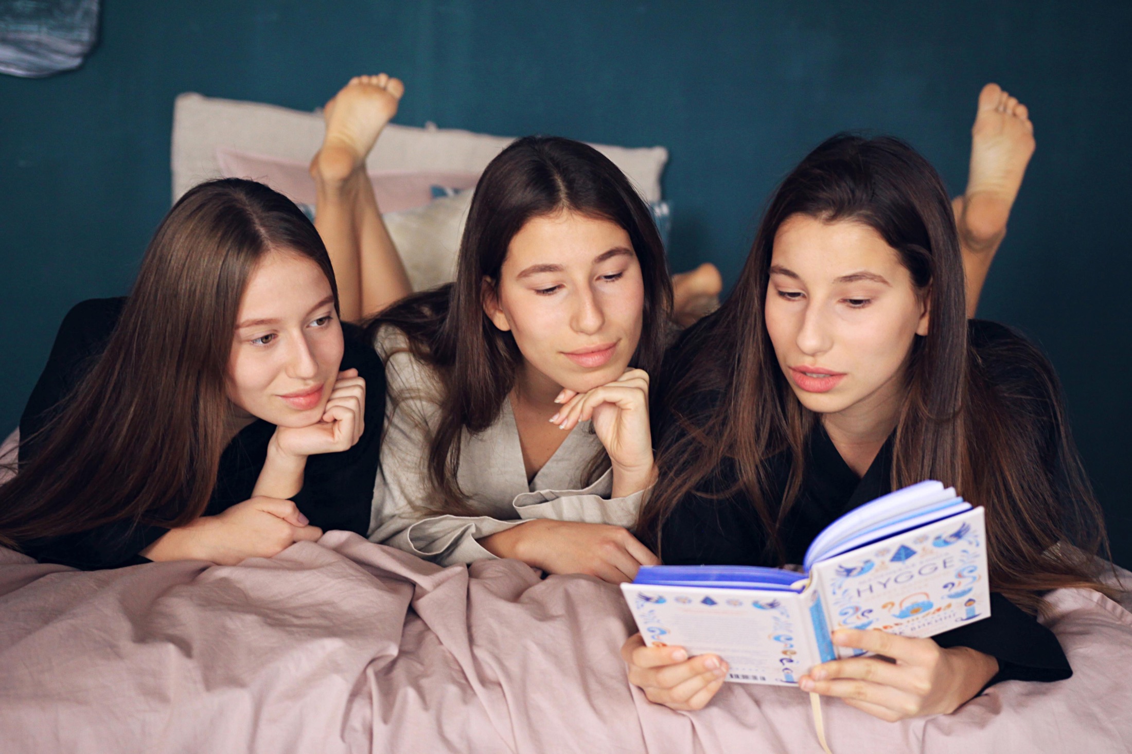 Three models reading in Veresk Clothes robes