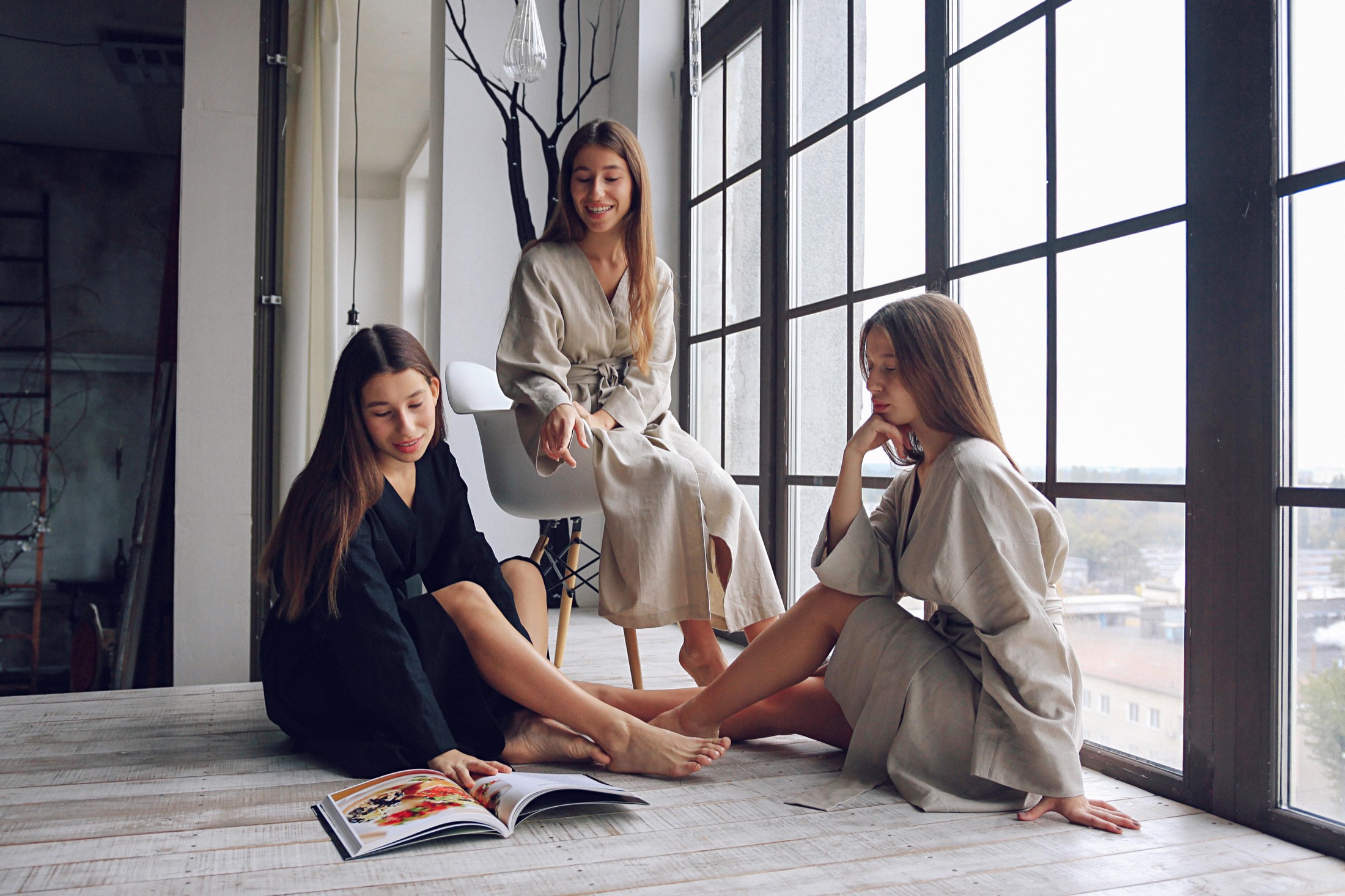 Three models by studio windows in Veresk Clothes robes