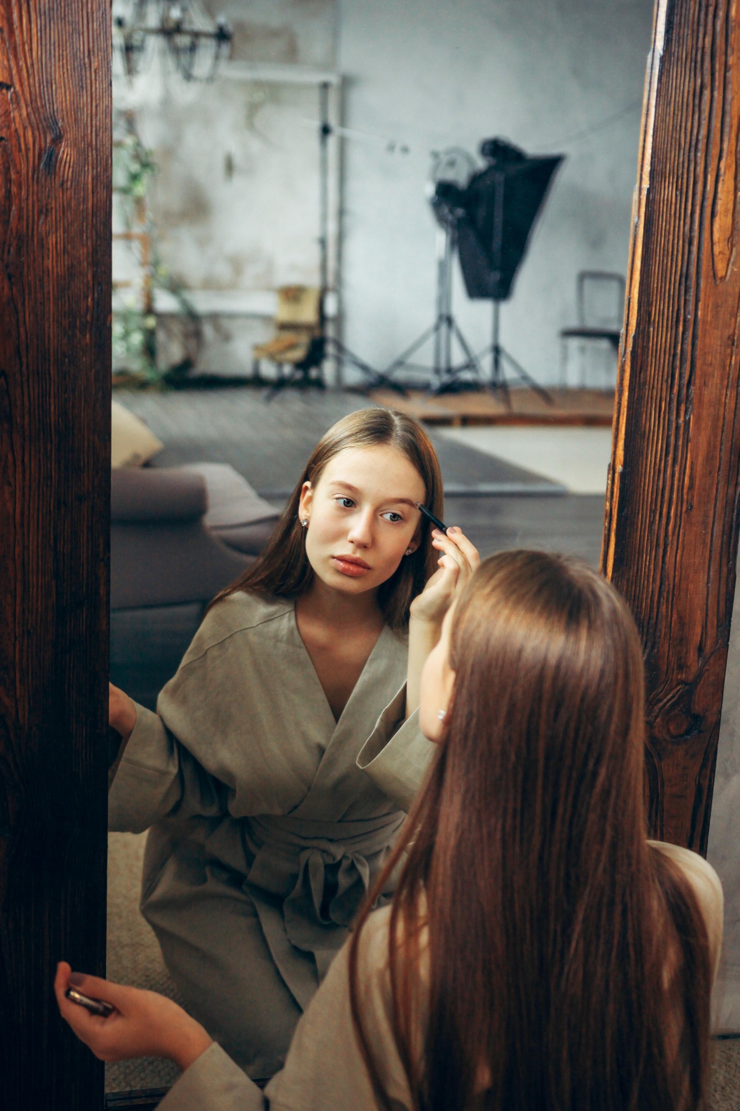 Model applying makeup in a Veresk Clothes robe