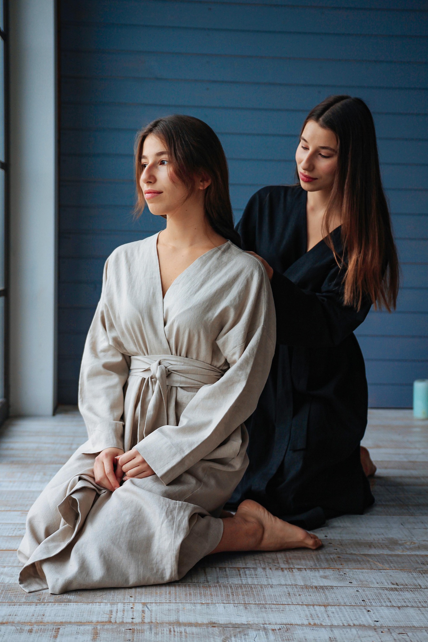Two models styling hair in Veresk Clothes robes